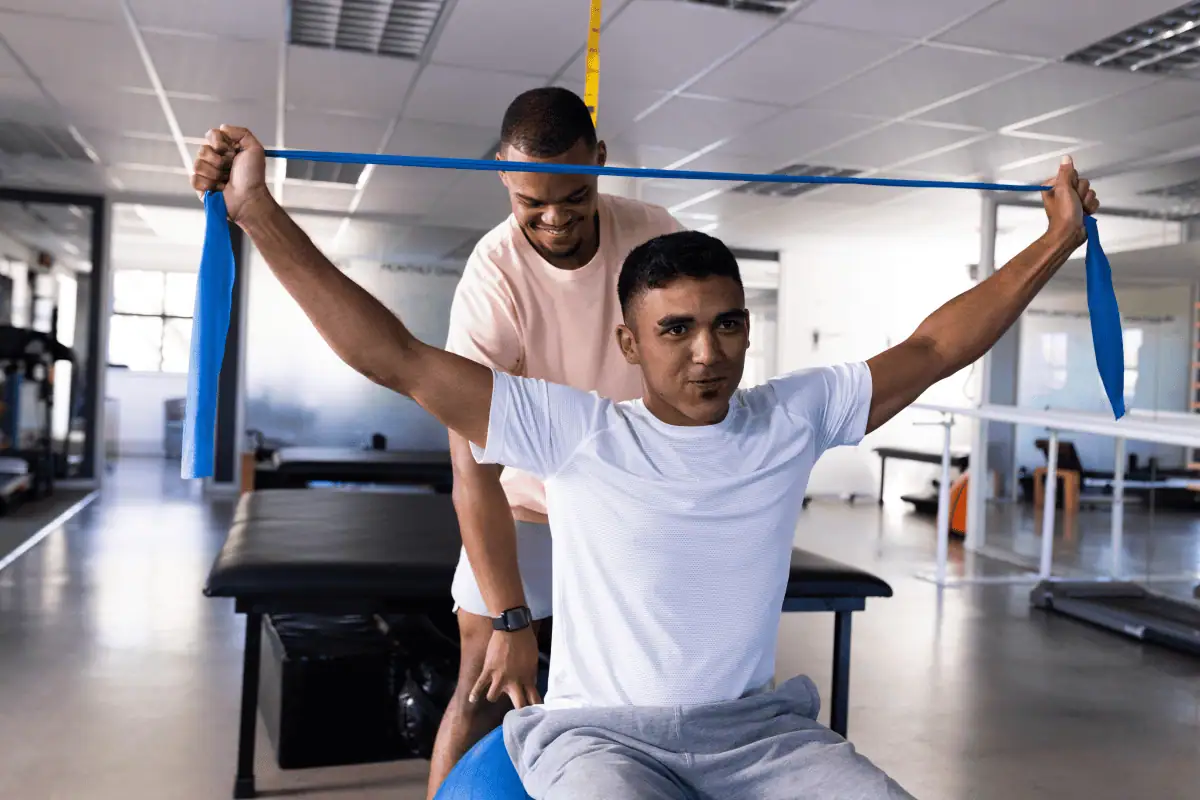 Trainer and guy at a gym.